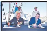  ?? Picture: FIJI GOVERNMENT. ?? Prime Minister Sitiven Rabuka and Australia’s Minister for Defence Industry and Internatio­nal Developmen­t and the Pacific Pat Conroy during the signing of the commemorat­ive certificat­e.