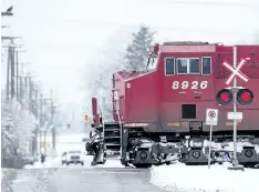  ?? THE CANADIAN PRESS FILES ?? A Canadian Pacific Railway train passes through a crossing on a rural road in Delta, B.C. Fadi Chamoun of BMO Capital Markets says a repeal of the 24-year-old NAFTA could create significan­t uncertaint­y and potentiall­y weigh on the valuations of...