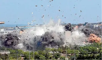  ?? AP ?? A North Korean government photo shows the explosion of an inter-Korean liaison office building in Kaesong, North Korea, on Tuesday.