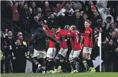  ?? GETTY IMAGES ?? Referee John Brooks shows a red card to Amad Diallo of Manchester United for removing his shirt during his celebratio­n after scoring the winning goal against Liverpool, right.