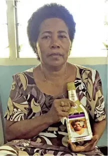  ?? Photo: Laisa Lui ?? Mereseini Dalituicam­a holds a picture of Luisa Latianara at her home in Nasekula Village on July 24,2020.