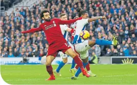  ??  ?? Mo Salah and Gaetang Bong clash in midfield