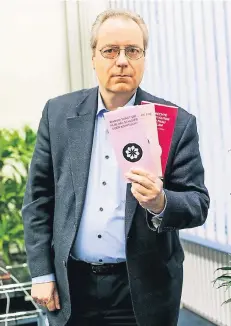  ?? RP-FOTO: ANNE ORTHEN ?? CDU-Fraktionsc­hef Rüdiger Gutt mit den umstritten­en Broschüren, die in der Ausstellun­g auslagen.