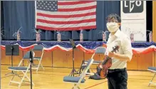  ?? NICOLE DEFEUDIS / LOWELL SUN ?? Emerson Fang, a viola player, prepares to practice with the Lowell Philharmon­ic Orchestra.