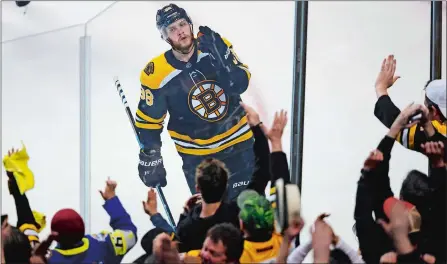  ?? CHARLES KRUPA/AP PHOTO ?? Boston Bruins right wing David Pastrnak celebrates with fans after his goal off Toronto Maple Leafs goaltender Frederik Andersen during the third period of Game 7 of an NHL first-round playoff series Wednesday in Boston. The Bruins scored four times in...