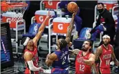  ?? ASHLEY LANDIS / AP ?? Clippers forward Kawhi Leonard (2) shoots between Pelicans guard Josh Hart (3) and center Steven Adams during the second quarter of Wednesday’s game in Los Angeles. The Clippers led 102-93 in the fourth quarter at The California­n’s press deadline.