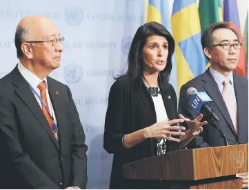 ?? — Reuters photo ?? Haley speaks to the press while Japan’s UN ambassador Koro Bessho (left) and South Korea’s UN ambassador Cho Tae-yul (right) look on after meeting on North Korea’s launch of ballistic missiles at the United Nations in New York.