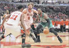  ??  ?? Boston Celtics’ Jae Crowder looks to dribble around defenders Chicago Bulls’ Robin Lopez (centre) and Jimmy Butler during the second half in game three at United Centre. — USA TODAY Sports photo