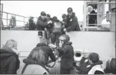  ?? AMANDA MCERLICH / NEWZEALAND DEFENSE FORCE VIA AP ?? Evacuees board the naval ship HMNZSCante­rbury onWednesda­y to leave the earthquake-hit town of Kaikoura.