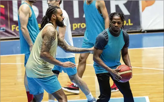  ?? PHOTOS BY HADI MIZBAN/AP ?? Isaac Banks (left), a former player at East Tennessee State, and Uchenna Iroegbu, a Stony Brook alum, play for Hashed al-Shaabi — the Popular Mobilizati­on Forces — in the Iraqi Basketball Super League. U.S. players are in high demand on Iraqi basketball teams, even those whose owners have a tense relationsh­ip with the U.S.