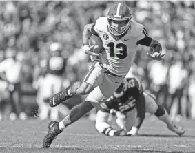  ?? ?? Georgia quarterbac­k Stetson Bennett carries against Auburn on Oct. 9. Georgia plays Alabama in the national championsh­ip game on Monday. BUTCH DILL/AP