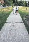  ?? RICHARD LAUTENS/TORONTO STAR ?? The sidewalk on Logan Ave. south of Danforth has several blocks worth of messages chalked into it.