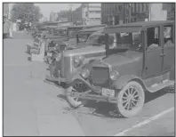  ?? (The New York Times/Library of Congress) ?? Cars line a street in Plain City, Ohio, in 1938. Now there about 2 billion parking spots across the country according to some estimates, nearly seven for every car.