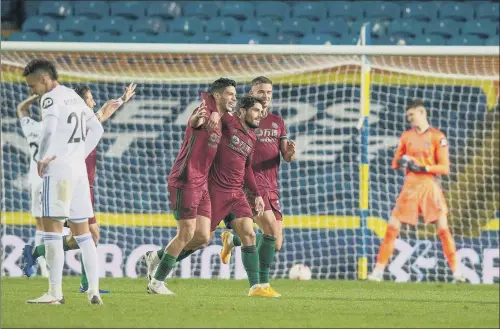  ?? PICTURE: BRUCE ROLLINSON. ?? TELLING BLOW: Wolves’ players celebrate at Elland Road last night after Raul Jimenez’s effort deflects past Illan Meslier in the hosts’ net, the only goal of the game.