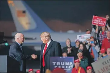  ?? Carolyn Kaster Associated Press ?? REP. GREG GIANFORTE, a Republican from Montana, greets President Trump in Missoula on Thursday night. Gianforte pleaded guilty to a misdemeano­r assault charge after his May 2017 attack on a reporter.