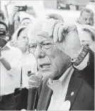  ?? CARLOS OSORIO THE ASSOCIATED PRESS ?? Democratic presidenti­al candidate, Sen. Bernie Sanders, holds an insulin vial outside a pharmacy in Windsor, Ont.