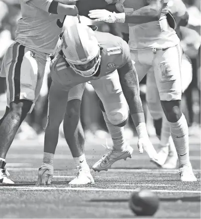  ?? CAITIE MCMEKIN/NEWS SENTINEL ?? Tennessee linebacker Keenan Pili scrambles for a ball that was later ruled not a fumble, during a Sept. 2 game against Virginia in Nashville.