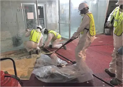  ?? PHOTOS BY ALLEY THEATER ?? Workers begin cleaning up Alley Theater in Houston, which was heavily flooded after Hurricane Harvey.