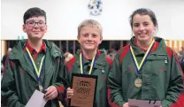  ?? PHOTO: GRETA YEOMAN ?? Clued up . . . Ashsurton Intermedia­te pupils (from left) Matthew Wong, Qam Orr and Amelie DickRosert­son (all 12) took first place in the years 7 and 8 quiz last night, answering 95 out of 100 questions correctly.