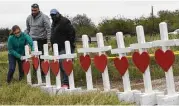  ?? Mark Ralston / AFP/Getty Images ?? Crosses are erected Wednesday outside the First Baptist Church of Sutherland Springs, scene of Sunday’s massacre that shocked the nation.