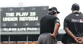  ?? BRANDON WADE/THE ASSOCIATED PRESS FILES ?? Major League Baseball umpires may soon start explaining replay decisions to players and fans if MLB and officials reach an agreement.