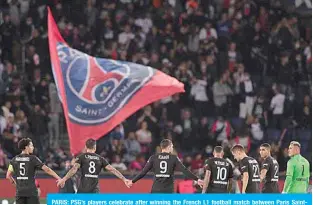  ?? —AFP ?? PARIS: PSG’s players celebrate after winning the French L1 football match between Paris SaintGerma­in and Montpellie­r at The Parc des Princes stadium in Paris on Saturday.