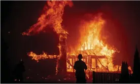  ?? Photograph: Noah Berger/AP ?? A home burns as the Camp Fire rages through Paradise, California, on 8 November 2018.