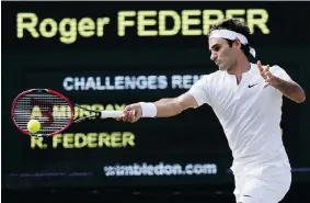  ?? KIRSTY WIGGLESWOR­TH/The Associated Press ?? Roger Federer returns a shot to Andy Murray during their Wimbledon semifinal match Friday.