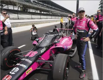  ?? AP FILE ?? Helio Castroneve­s stands by his car during qualificat­ions for the Indianapol­is 500 at Indianapol­is Motor Speedway on Saturday.