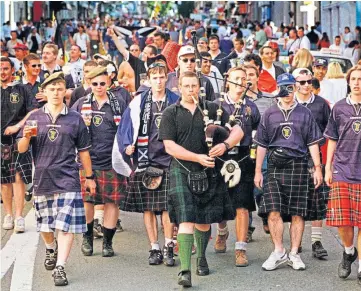  ??  ?? A section of the Tartan Army march down Rue Charles De Gaulle towards the Geoffroy Guichard Stadium for the final group game with Morocco in St Etienne.