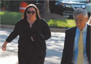  ?? AP PHOTO ?? Lee Elbaz, left, accompanie­d by her attorney Barry Pollack arrives at federal court for jury selection in her trial in Greenbelt, Md., on Tuesday. She is accused of duping investors through the sale and marketing of financial instrument­s known as “binary options.”