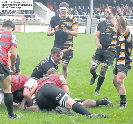  ??  ?? Merthyr celebrate a try in their weekend Premiershi­p win at Cross Keys