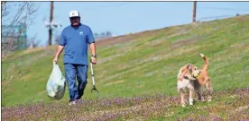  ??  ?? Below: Andres Renteria picks up trash while a dog fetches a ball.