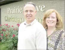  ?? DENISE NEMEC SPECIAL TO ENTERPRISE-LEADER ?? Prairie Grove Christian Church pastor Vance Edwards and his wife Lynda, who serves as church office manager, stand outside the sanctuary facing toward Prairie Grove Battlefiel­d State Park.