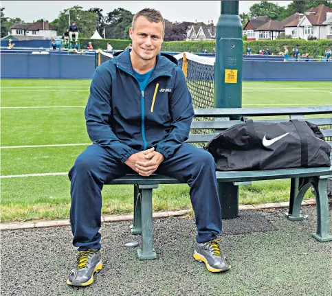  ??  ?? Addicted to tennis: Former world No 1 Lleyton Hewitt in Surbiton, south-west London, where he played a Challenger event. Inset, lifting the trophy at Wimbledon 16 years ago