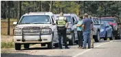  ?? CLYDE MUELLER/THE NEW MEXICAN ?? BELOW: Road blocks are set up at the intersecti­on of N.M. 4 and N.M. 501 on Thursday.