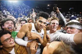  ?? RICK BOWMER / AP ?? BYU’s Yoeli Childs celebrate with fans following their victory over Gonzaga following an NCAA college basketball game Saturday in Provo, Utah.