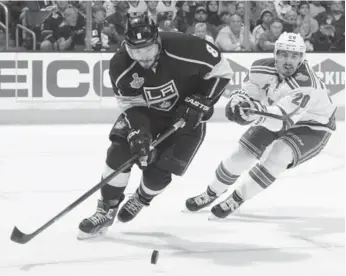  ?? ANDREW D. BERNSTEIN/NHLI VIA GETTY IMAGES ?? Kings blueliner Drew Doughty, left, controls the puck while pursued by New York’s Chris Kreider during Game 1.
