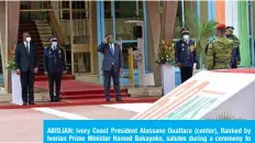  ?? — AFP ?? ABIDJAN: Ivory Coast President Alassane Ouattara (center), flanked by Ivorian Prime Minister Hamed Bakayoko, salutes during a ceremony to mark the 60th anniversar­y of the country’s Independan­ce from France on August 7, 2020.