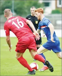  ??  ?? MATCH-WINNER: Whitby’s Davey Carson pushes his way past Barwell substitute Declan Towers