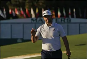  ?? CHRIS CARLSON - THE ASSOCIATED PRESS ?? Jon Rahm, of Spain, holds his ball after a birdie on the ninth green during the second round of the Masters golf tournament Friday, Nov. 13, 2020, in Augusta, Ga.