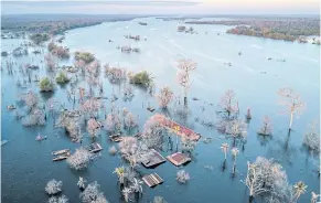  ?? NYT ?? This 2018 photo shows Srekor village in Cambodia, submerged when the reservoir for the Lower Sesan 2 dam began overflowin­g in late 2017.