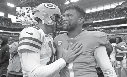  ?? GETTY IMAGES ?? Aaron Rodgers of the Green Bay Packers greets Tua Tagovailoa of the Miami Dolphins.