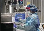  ?? Bob Owen / Staff photograph­er ?? Tracie Sandoval tends to a patient in one of four COVID-19 units at Methodist Hospital on June 25.