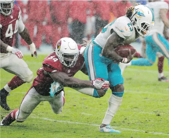  ?? — THE ASSOCIATED PRESS ?? Arizona Cardinals linebacker Sio Moore tackles Miami Dolphins running back Jay Ajayi in Sunday’s game in Miami.