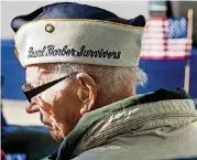  ??  ?? Pearl Harbor survivor Ivan Stewart lowers his head in prayer during the Pearl Harbor remembranc­e ceremony at the USS Oklahoma Anchor in Campbell Art Park on Thursday in Oklahoma City.