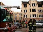  ?? NANCY STONE/CHICAGO TRIBUNE ?? Above: Firefighte­rs work at a November 2014 fire in the Hollywood Park neighborho­od where a 10-year-old boy died on the top floor. Multiple tenants said they heard no smoke alarms.