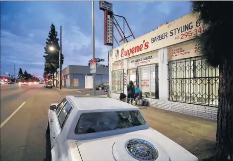  ?? Allen J. Schaben Los Angeles Times ?? EUGENE’S BARBERSHOP is a neighborho­od gathering place on Martin Luther King Boulevard, a street of demarcatio­n in South L.A.