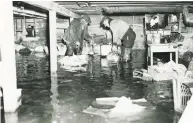  ??  ?? A flooded cellar in a neighborho­od along the Byram River after the great hurricane of 1938.
