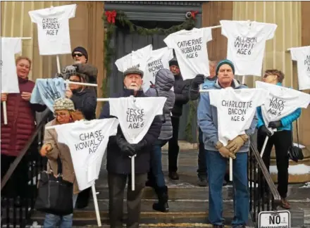  ?? BILL RETTEW JR. — DIGITAL FIRST MEDIA ?? Marchers hold T-shirts with the names of Sandy Hook Elementary School students and staff on Sunday at the Historic Chester County Courthouse in West Chester to mark the five-year anniversar­y of the mass shooting at the school in Connecticu­t.